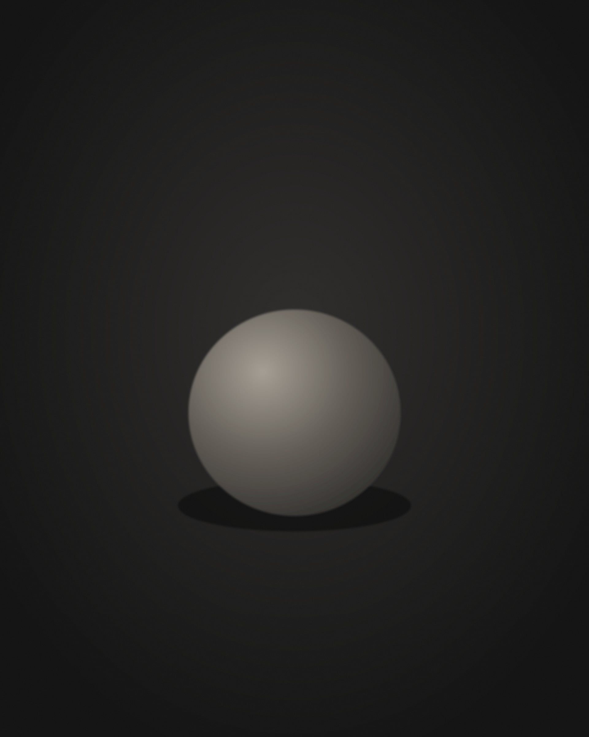 A worn object resting alone in a pool of soft light on black velvet.
